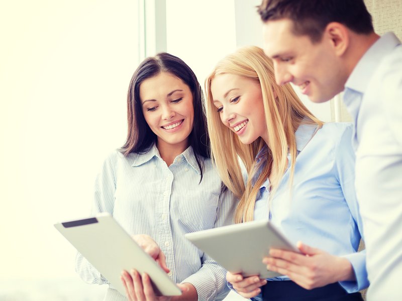 Launch Point Marketing team members reviewing strategy together on tablets