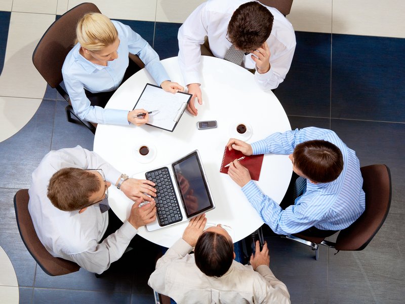 Launch Point Marketing team members collaborating around a table during a strategy meeting